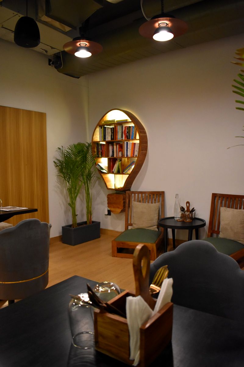 The reading corner with its round bookshelf at The Calm Cup
